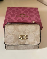 Coach Leather bi-fold wallet w/ two zippered pockets